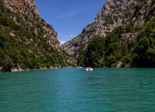 Tourists explore the Verdon Gorge in pedal boats, kayaks and paddle boats. An ideal place for an active holiday in Provence-Alpes-C&ocirc;te d'Azur, France.