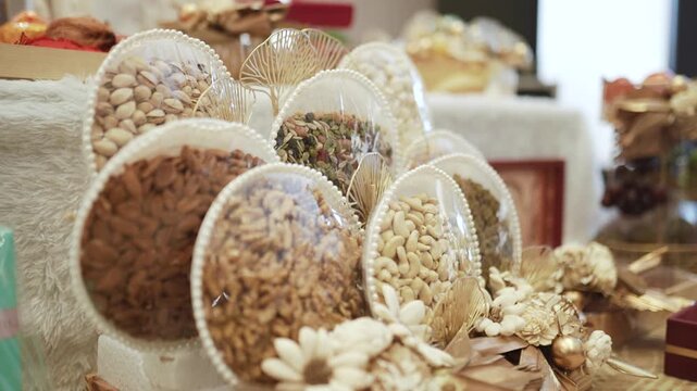 Luxury dry fruits gift hampers packed in round decorative platters with pearls for Indian wedding ceremony