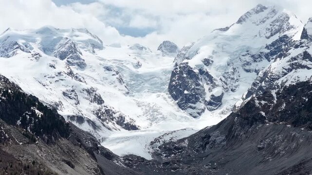 Morteratsch Glacier descends between snow-covered alpine peaks, Engadin, Graub&uuml;nden, Switzerland