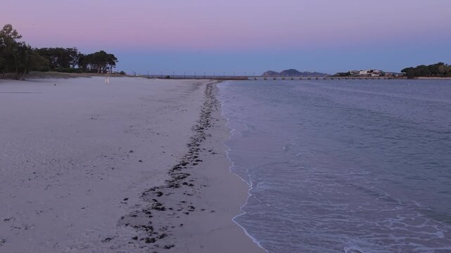 Aerial sunrise over Playa del Vao beach and Toralla Bridge in Vigo, Galicia, Spain