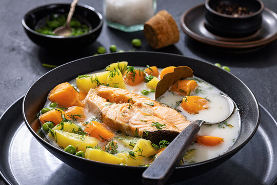 fish soup featuring a large chunk of salmon