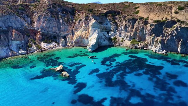 drone shot of Firopotamos beach in Milos, Greece, crystal clear water of the Aegean Sea on a Greek island in the Mediterranean, summer vacation on Milos, aerial view of turquoise sea with cliffs