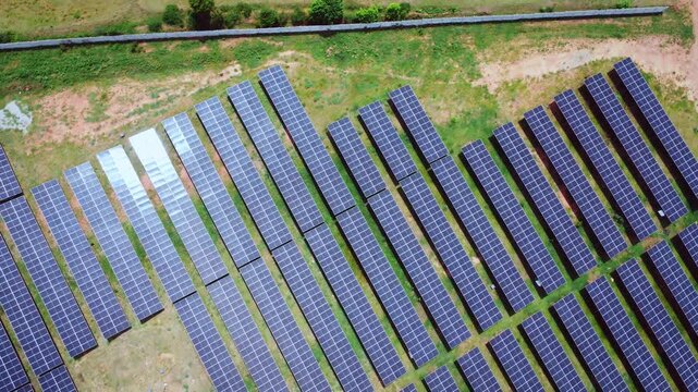 4K aerial drone view of a large solar panel installation in India, showcasing photovoltaic technology, renewable energy infrastructure, and utility-scale solar power generation.