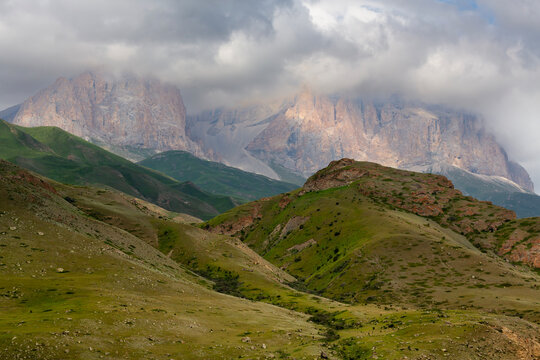 The green slopes and rocky summits of the Caucasus Mountains in Chegem Gorge