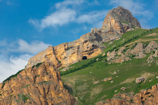 The green slopes and rocky peaks of the Caucasus Mountains in Chegem Gorge