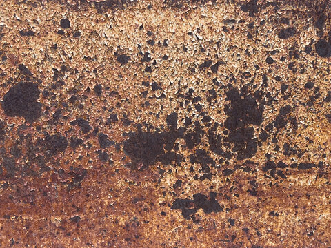 Rusty weathered metal surface with heavily corroded texture