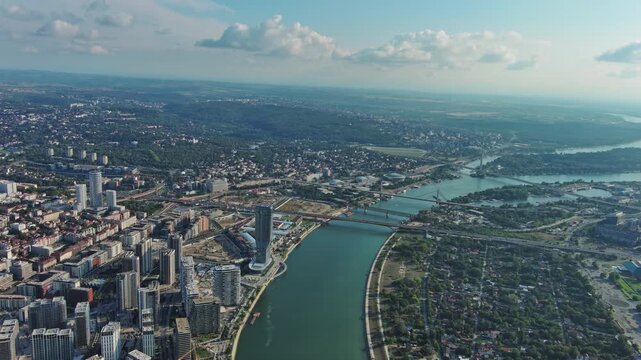 Aerial view of Belgrade at confluence of Sava and Danube rivers. Urban landscape, forested river island and city view, 4k