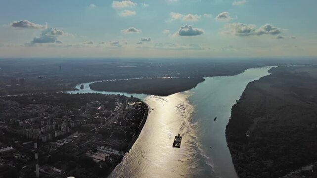 Aerial view of Belgrade at confluence of Sava and Danube rivers. Urban landscape, forested river island and city view, 4k