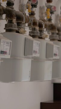 Vertical Screen: The process of installing gas meters and pipes in a block of flats is shown. The technicians check equipment and ensure proper functioning of the gas system.