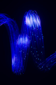 Undulating fiber arc with luminous data particles and neon glow 3D
