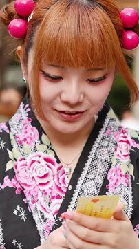 Japanese Woman in Kimono Reading Omikuji Fortune at Tokyo Shrine
