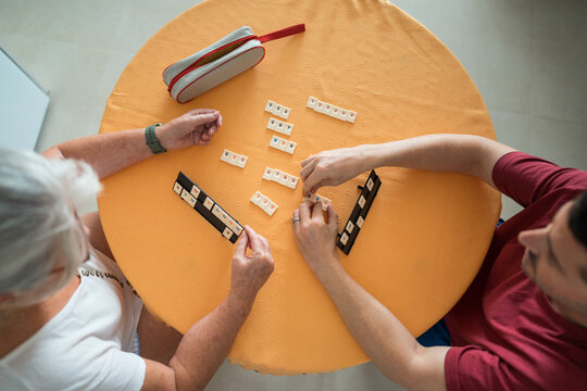 Mother and son enjoy a tabletop game together at home