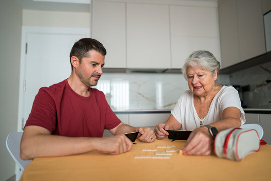 Mother and son enjoy family game time at home