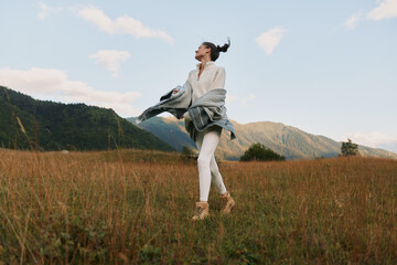 Obraz premium Cheerful woman outdoors in a sunlit field, carefree posture, natural colors, light breeze, relaxed lifestyle moment, joyful smile toward the horizon