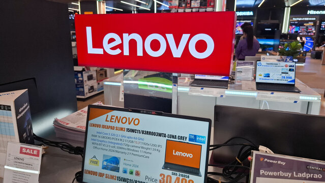 Red lenovo brand logo illuminated sign with ideapad laptop display in electronics retail store close up view on September 22, 2026 in Bangkok, Thailand 