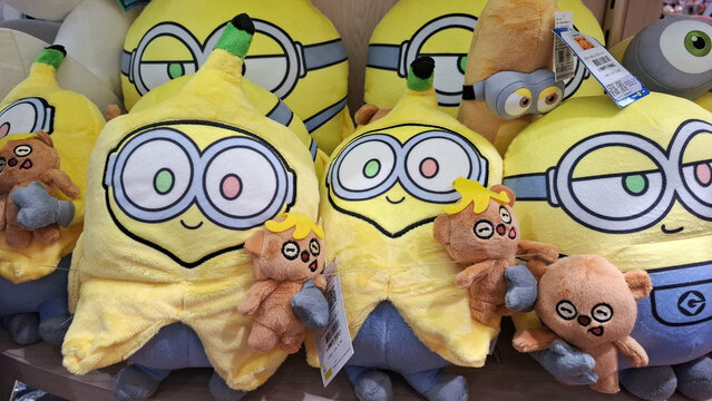 Cute minions banana plush toys and tim teddy bear displayed on shelf in retail store close up view on September 8, 2026 in Bangkok, Thailand 