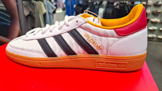 white adidas spezial sneaker shoe with black three stripes and yellow red lining on red box in retail store on July 29, 2026 in Bangkok, Thailand 