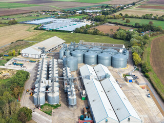 Interesting drone UAV view of a large grain drying silo complex in the Cambridgeshire, UK countryside. The large silos store locally and nationally produced grains at harvest time. © Nick Beer