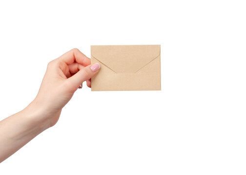 Hand holding a brown envelope in a plain background