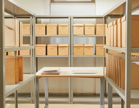 Organized office records archive with storage boxes and file folders