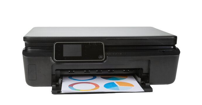 Printer producing color printed paper with circular designs on a white background in a home office setup
