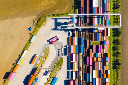  Aerial view of containers at railway. Big container terminal on a railroad with open storage area.