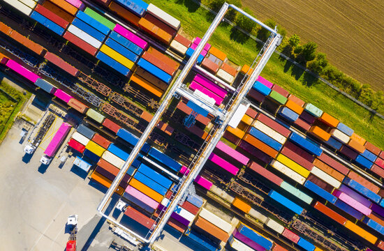  Aerial view of containers at railway. Big container terminal on a railroad with open storage area.