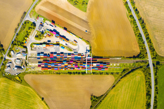  Aerial view of containers at railway. Big container terminal on a railroad with open storage area.