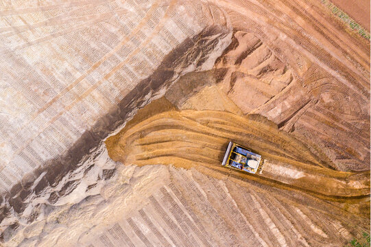 Excavator on a construction site. Aerial view from european industry.