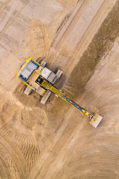 Excavator on a construction site. Aerial view from european industry.