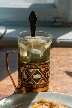 Hot tea in a glass with a teabag in a vintage metal glass holder