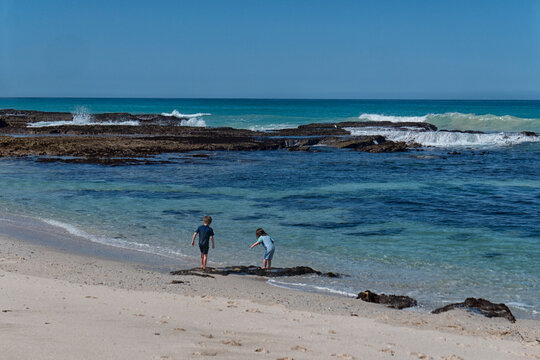 Boy and girl playing on the Indian Ocean beach