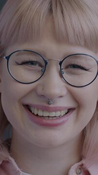 Slow motion portrait of joyful young woman laughing looking at camera on black background. Positive emotion and happy people concept.