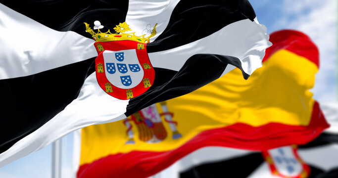 Ceuta and spanish national flags waving on a clear day