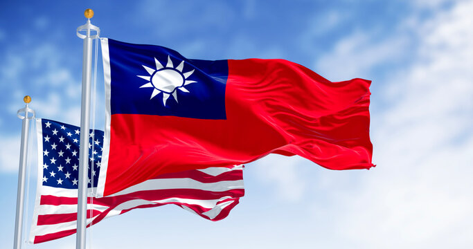 National flags of Taiwan and USA waving in the wind on a clear day