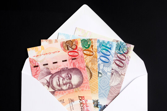 Botswana pula in a white envelope on a black background