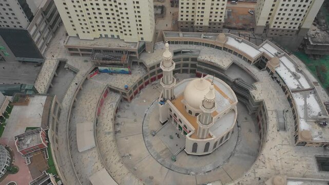 Rotating drone shot of modern mosque in residential and commercial district in Xining, China
