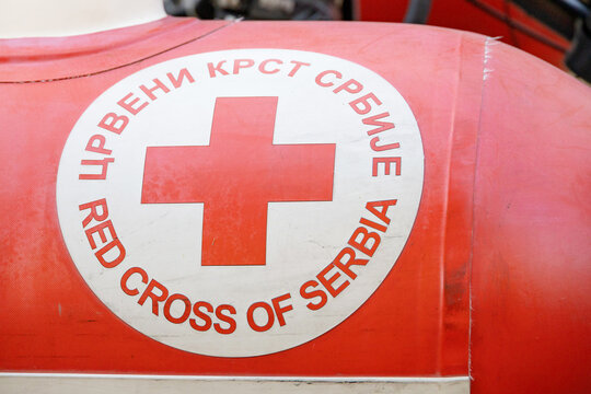 8 August 2026, Belgrade, Serbia: Red Cross symbol displayed on red inflatable equipment, representing humanitarian aid, relief, and medical support