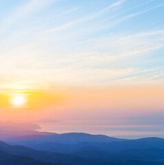 Fototapeta premium mountain slope silhouette above the sea bay at the sunrise, early morning sea coast scene