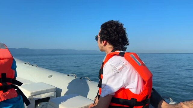A young man travels on a speedboat moving quickly after leaving the marina in Nuevo Nayarit.