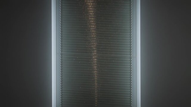 Shifting sun causing window with closed venetian blinds forming narrow sparkly streak in small room