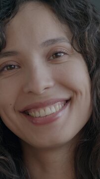 Slow motion portrait of happy Middle Eastern lady laughing looking at camera on black color background. People and positive emotion concept.