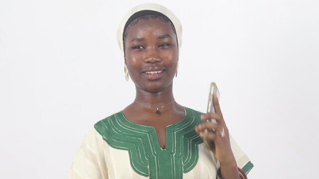Smiling young woman on the phone pointing at the camera