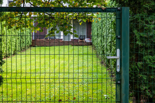 Closed Green Metal Gate at a Private Residential Garden