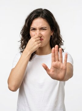 Young Woman Pinching Nose and Showing Stop Gesture Due to Bad Smell Isolated on White Background