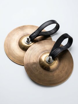 Pair of Professional Brass Finger Cymbals with Black Leather Straps Isolated on White Background for Belly Dance