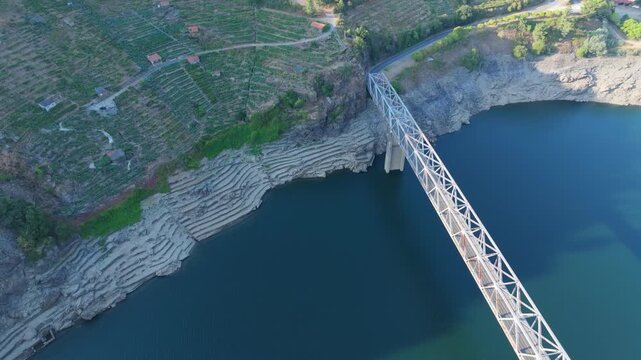 An Aerial View Captures Mourulle Bridge Spanning the Water in Xill&aacute;n, Chantada, Spain - Orbit Drone Shot