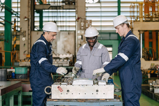 Professional engineer team worker men group service maintenance injection mold in die casting plant.