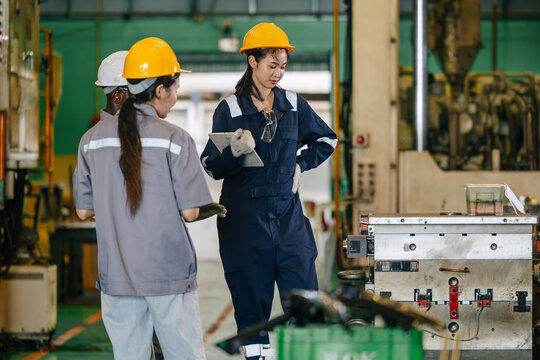 Engineer women workers team working check inspecting injection mold in die casting automotive parts.