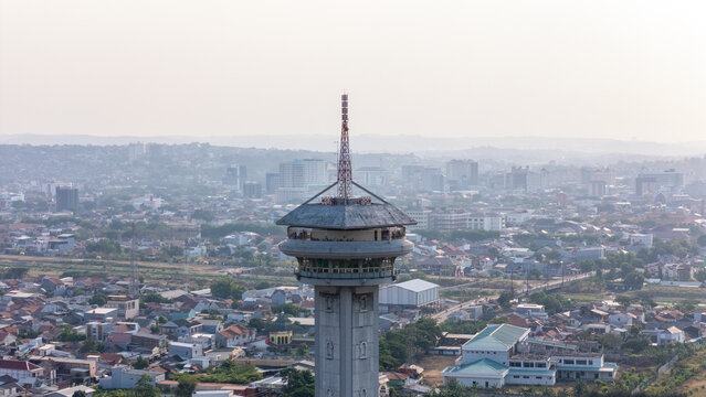 Aerial view of the observation tower overlooking the sprawling cityscape and residential rooftops in Semarang, Central Java, Indonesia.